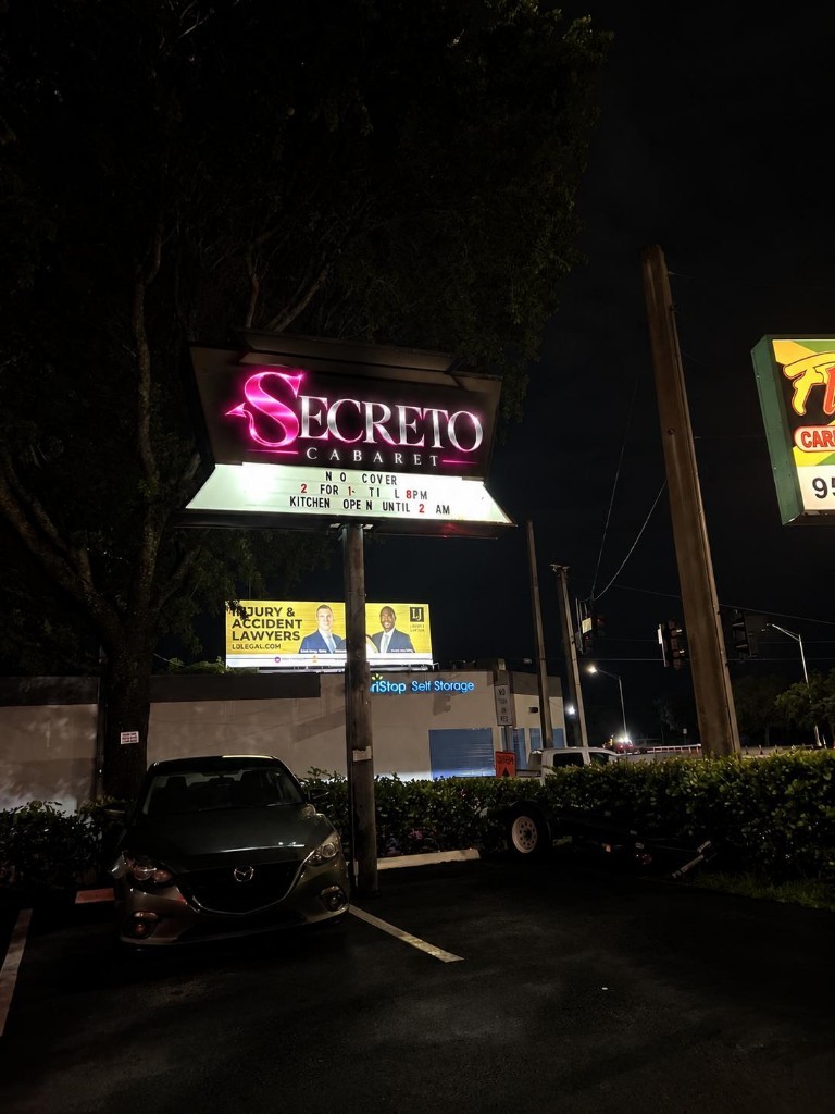 Secreto Cabaret roadside sign at night in Pompano Beach